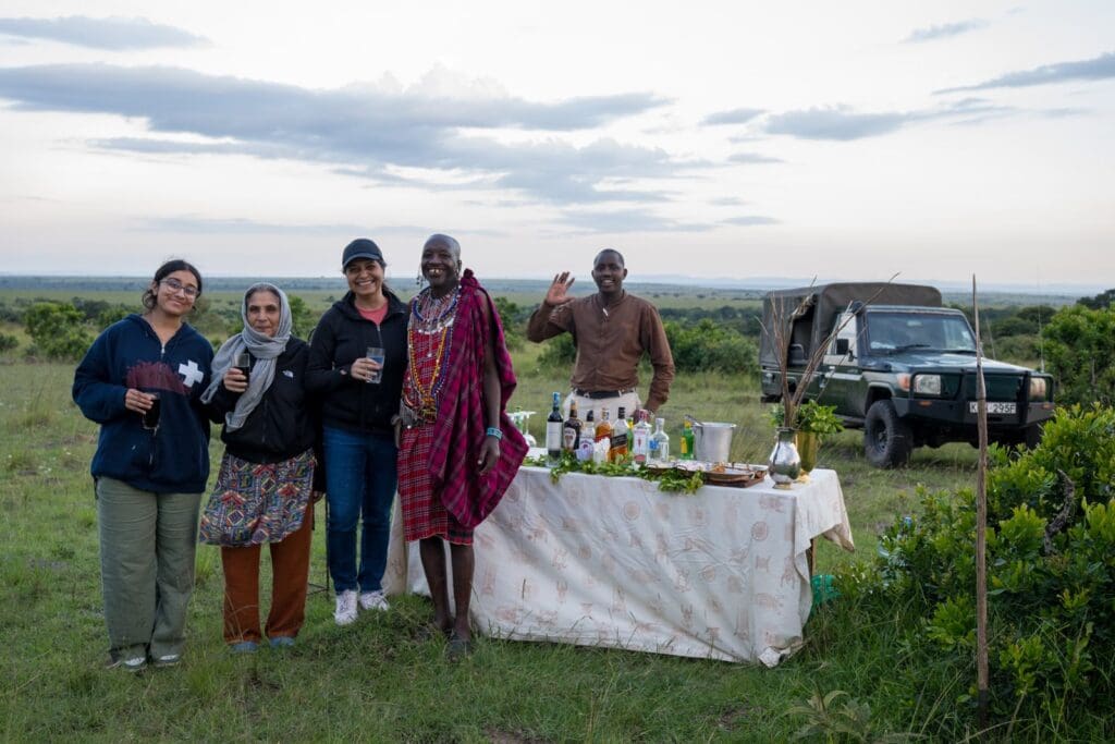 Group tour photo with guide on safari with Elephant Pepper Camp Mara